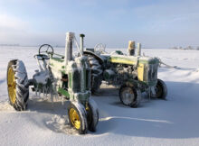 John Deere tractors in the snow