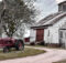 Farmall tractor and big white barn