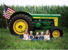 Kids with John Deere tractor in corn field