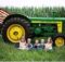 Kids with John Deere tractor in corn field