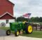 John Deere tractor, barn, dog and flag